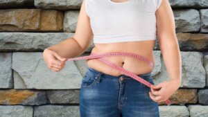 Mulher medindo barriga para perder peso